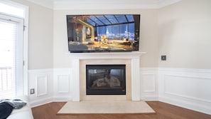 The fireplace offers a perfect gathering setting.
