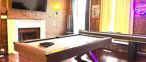 Rack 'em up and unwind in style: Enjoy endless entertainment in our inviting space with a sleek pool table!