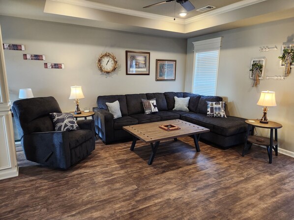 Living room with USB lamps (3 way lighting) - couch and recliner and tables.