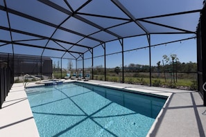 Oversized heated pool, complete with hot tub with four chaise lounge chairs. Pool comes with colored LED lights to ensure any night swims magical.