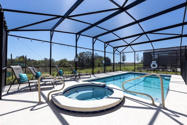 Oversized heated pool, complete with hot tub with four chaise lounge chairs. Pool comes with colored LED lights to ensure any night swims magical.