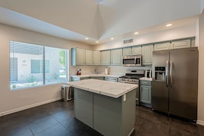 Kitchen with open to above loft area