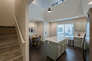 Kitchen with open to above loft area. Stairs to 2nd floor.