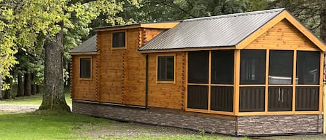 Luxurious cabin with screened-in, furnished porch.