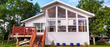 Exterior view of the house, on the lake side, showing deck and sunroom.