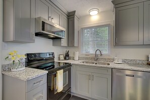 Kitchen with granite countertops, modern appliances 