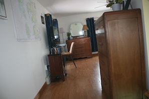 View looking to the right at the top of the stairs into the bedroom with desk