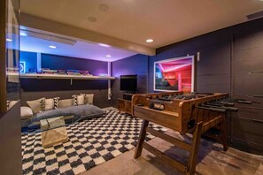 The downstairs media room features a star tv, foosball, puzzles, board games, books, and DVD's.