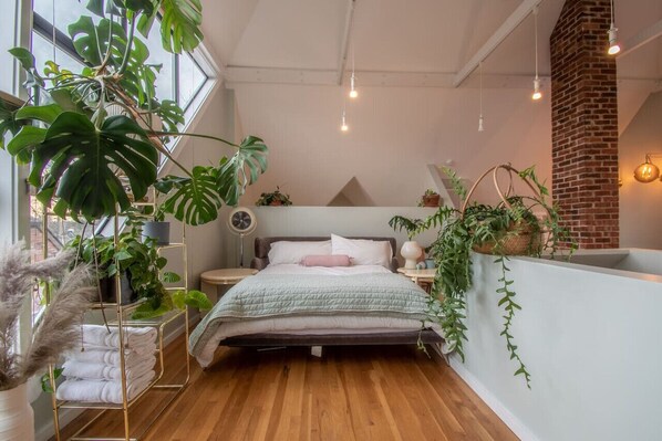 Loft is on the second floor of the home with beautiful large windows. The room features a queen bed and a smart TV.