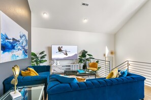 Spacious Living Room with large 70" Samsung Smart TV and seating for 6