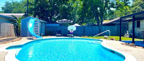 Poolside paradise: Slide, splash, and score in our backyard oasis