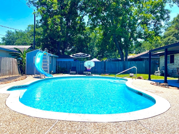 Poolside paradise: Slide, splash, and score in our backyard oasis