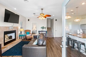 A crackling fireplace creates a cozy atmosphere, perfect for movie nights!
