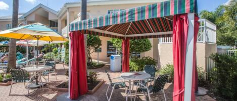 Take a load off under the outdoor cabana near the pool. 