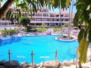 Bright and big and very welcoming pool with lots of sunbeds.