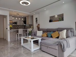 Living room with small coffee table where you can relax in the evening to watch TV or a movie
