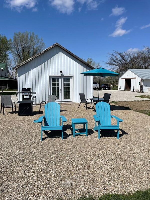 Stone Patio Area complete with a gas grill, Propane fire pit and outdoor dining