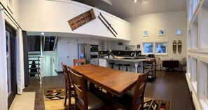 Kitchen w/ large island, dining room table, breakfast nook, deck access and TV
