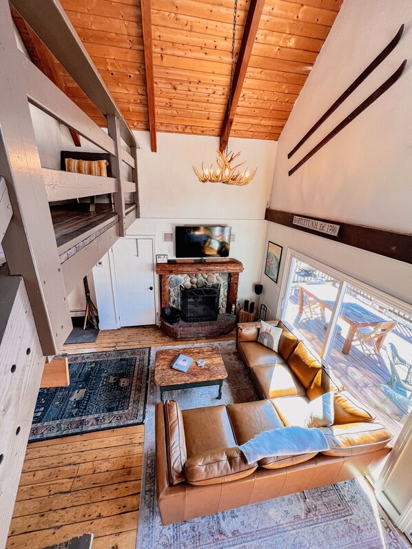 Basement Living room with fireplace, 60-inch TV,  has access to the lower level of the property.