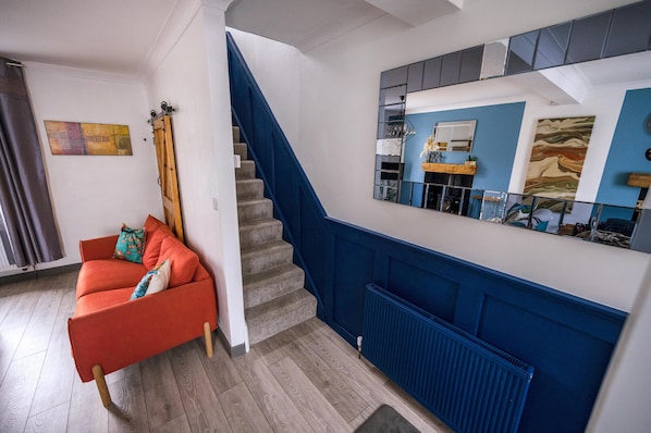 living room with stairs leading to bedroom