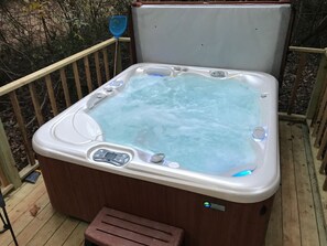 Shared Hot Tub. Large Hot Springs Hot tub on a deck with overhead Edison string lights. Perfect for a romantic evening soak.4 cabins share access to this Hot tub. It located in a hidden spot in the woods,  accessible to all 4 cabins.