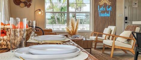 Large Dining Room table to fit the whole group! Beach chic professionally designed decor and furniture with a custom Toasted Coconut light up sign for some pizzaz!