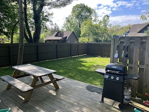 fully fenced in yard, A deck w picnic table, chairs, bbq,