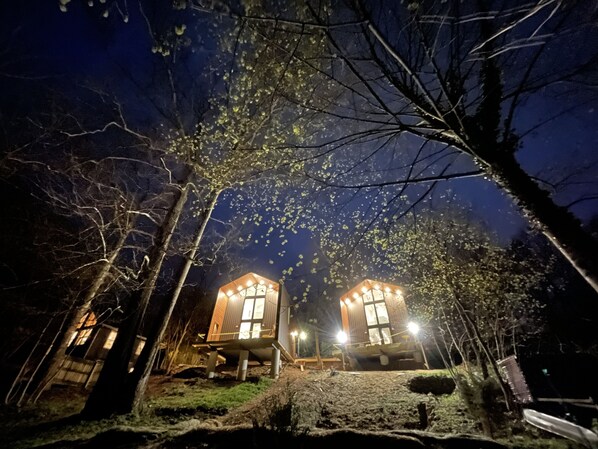 View of cottages from fire pit by the river 