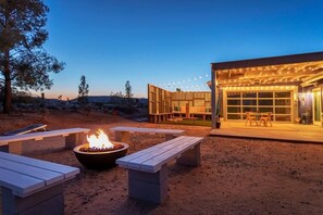 Luna: back patio with propane fire pit and benches for group seating