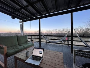 The back porch is the perfect place to listen to the birds & river.