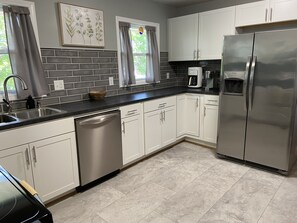 New full size dishwasher and fridge with ice maker.