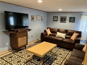 Large downstairs family room with new furniture and foosball.