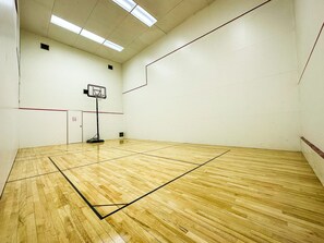 Full sized squash court w/ foursquare and a basketball hoop