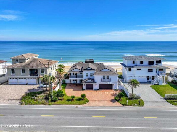 Aerial drone shot of home on ocean