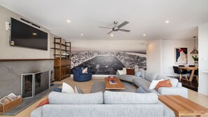 Open plan living and dining with smart TV and operational fireplace