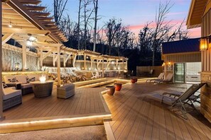 Magazine-worthy backyard space with waterfalls, fishpond, outdoor kitchen, and plentiful seating