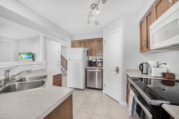 Bright and open kitchen with views of the living room and back yard