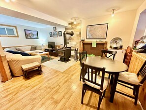 The large rec room in the walkout basement in the perfect place to work on a puzzle or play a board game. Light a fire in the wood stove to keep warm in the winter.