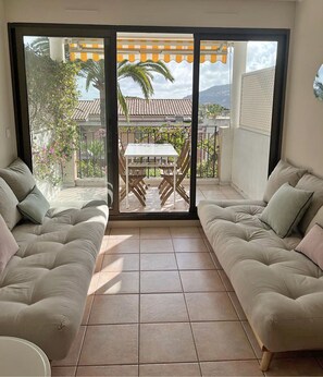 The living room with access to the balcony
