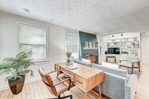 living room w dedicated workspace including desk and chair
