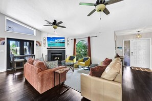 With a large TV, ample seating, our living room overlooks the pool area, with a queen size sofa bed. (1)