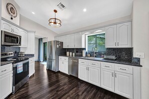 Fully equipped kitchen with all of the appliances, utensils, and amenities you need to prepare meals (1)