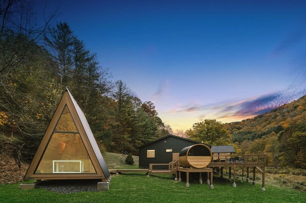 View of home, barrel sauna, A-frame, deck w/hot tub, shower, screened porch