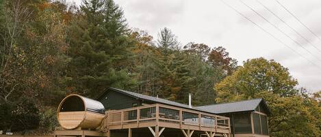 view from the meadow - barrel sauna, large deck with hot tub, screen porch