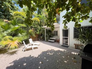 Private outdoor garden, with table and grill