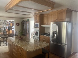 Modern kitchen with high end appliances, gas cooktop, double oven