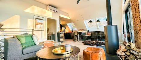 Sun soaked living room and kitchen surrounded by skylights