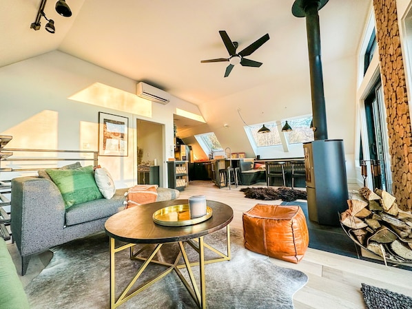 Sun soaked living room and kitchen surrounded by skylights