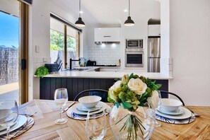 Stylish and sunlit kitchen-dining space, perfect for relaxed gatherings and home-cooked meals.