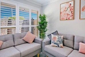 Bright and breezy living space with soft touches of blush and botanical charm